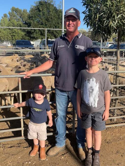 Quality Livestock agent Lawson Ryan with children Liam and Thomson at last week's Ouyen market. Picture supplied