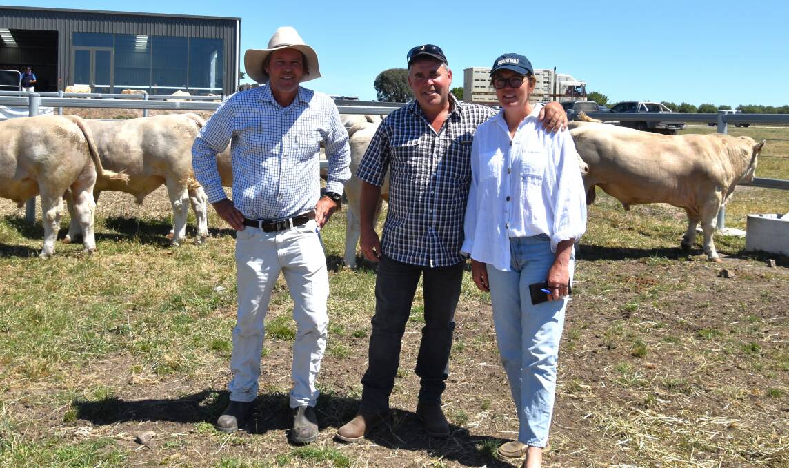 Mount William Charolais stud principal Rob Abbott, with buyers of three bulls at $5000 each Graham Robinson and Lesley Hasthorpe, Tanjil South.