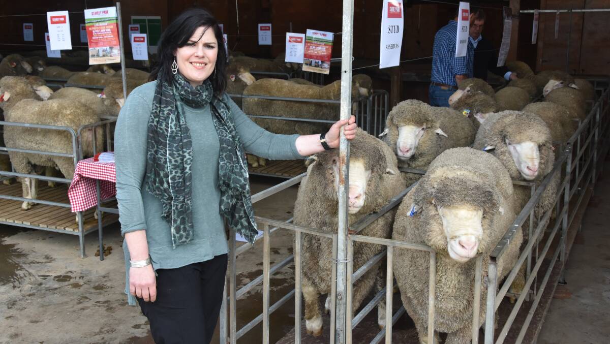 Stavely Park Merino stud co-principal Felicity Brady with some of the rams on offer.