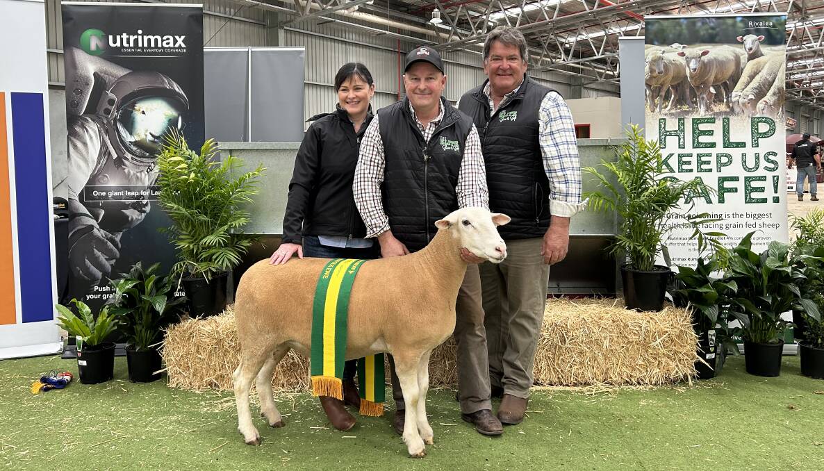 Shannon and Paul Day, Sunnybanks White Suffolks and Poll Dorsets, Penguin, Tas, and judge Ian Kyle, Ashley Park White Suffolk stud, Bairnsdale, with the champion White Suffolk ewe. Picture by Joely Mitchell