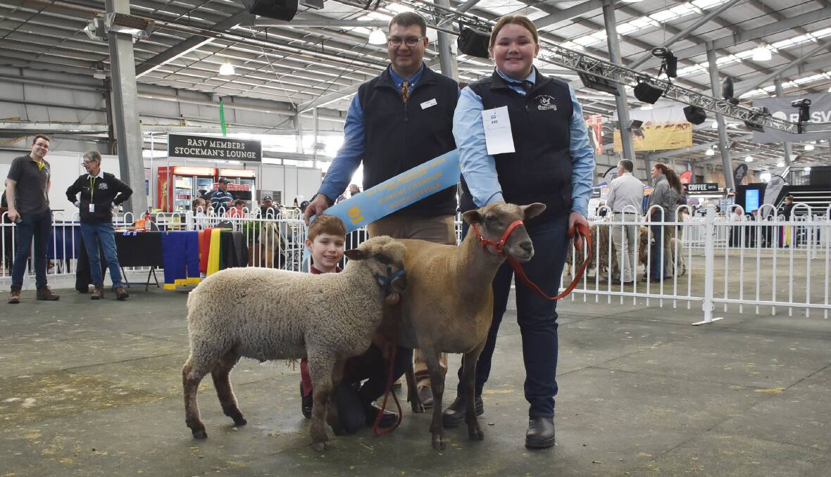 Josh Holmes and St Mary of the Angels Secondary College student Cassie Brooks, Nathalia, hold Willow Drive, Derrinallum, principal Barry Shalders' supreme South Suffolk exhibit, a two year-old ewe with her first lamb. They are pictured with judge Will Milroy (middle).