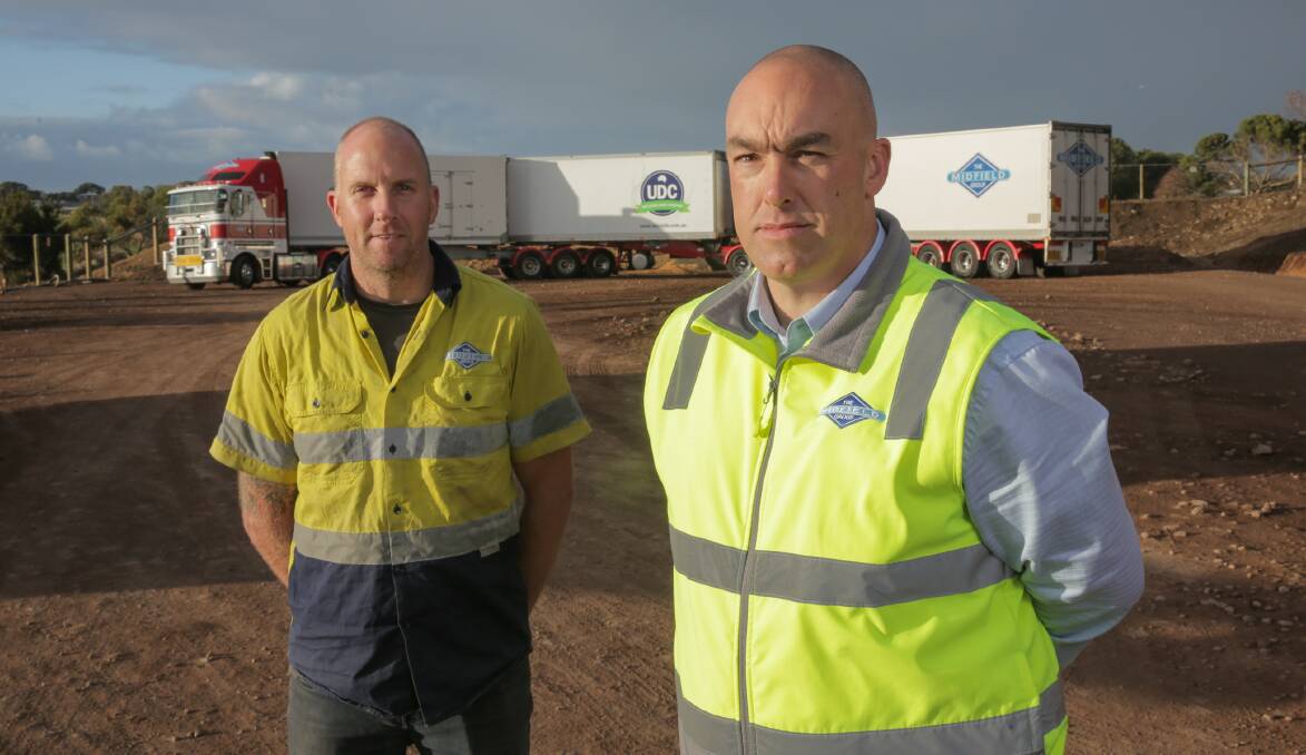 B-TRIPLE: The Midfield Group truck driver Shane Bartlett and transport manager Mark Leggett in front of one of the company's new B-triple trucks. Photo by Glen Watson.
