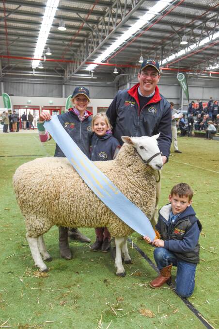 IN THE FAMILY: Elizabeth, 11, Christine, 9 and Jeffrey, 6, with their father Jeff Sutton, and their Wattle Farm stud's supreme Border Leicester at last year's ASWS.
