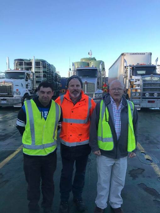 Don Flynn and John Lucas, Arnold's Petroleum, Smithton, Tas, with Robbie Wright, Wright's Transport, Devonport, Tas (middle), on a boat to Victoria with their hay trucks. Photo: Need for Feed.