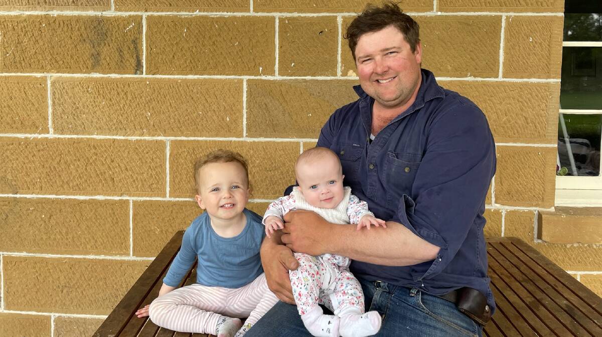 James Hume, with daughters Annabelle, 2, and Stella, five months, Dewent Valley, Tas, is passionate about the Merino breed. Picture supplied.