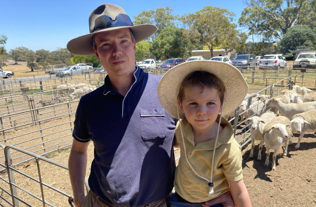 GRASS MOWERS: Mike Palmer and son Magnus, 5, bought shedding sheep at Mount Pleasant, SA, to put on their seven acres at Brukunga, SA.
