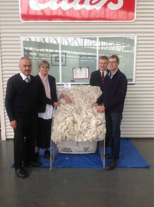 Tarrington woolgrowers Everard, Marilyn and Matthew Linke, with Elders district wool manager Andrew Howells, and some of their 1PP wool.