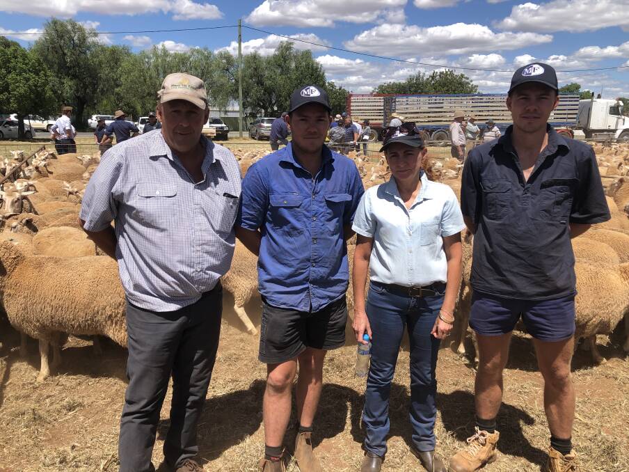 EXCHANGE: Buyer Neil Morris, Ardlethan, NSW, with vendors Nigel, Maree and Coden Colman, Ungarie, NSW, and their $478 ewes at Barellan, NSW. Photo by Kim Woods.