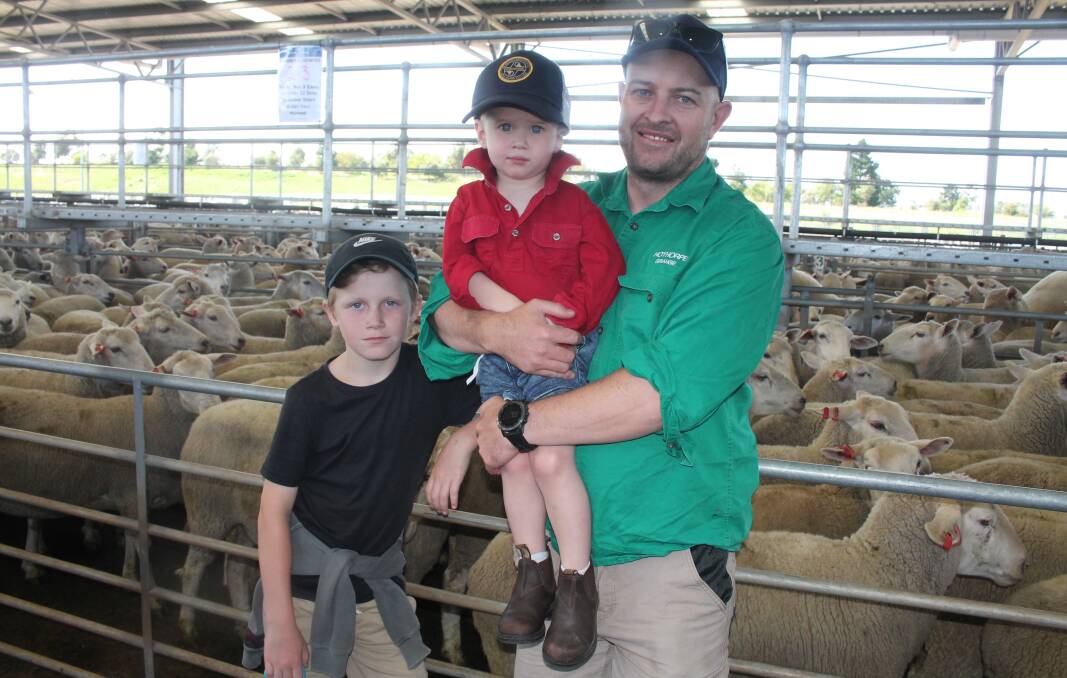 Logan Hutchins, 8, with his cousin and uncle Hudson, 2, and Joel Banks, Mount Mercer, at Ballarat's first-cross ewe sale earlier this month. Picture by Philippe Perez