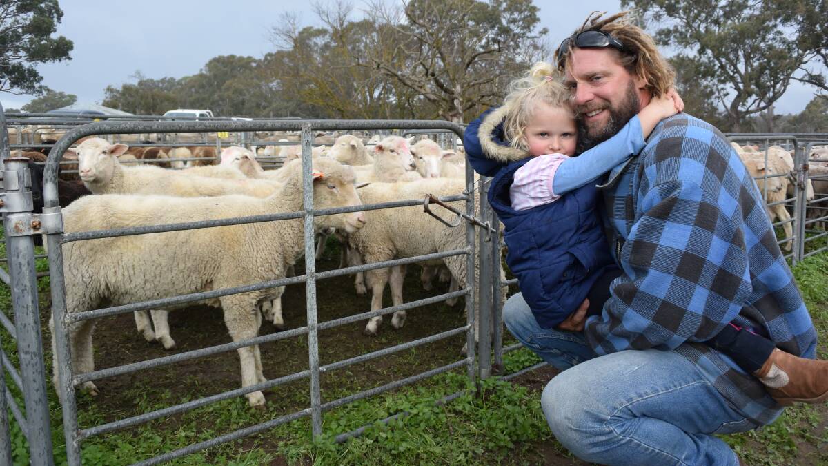 MARKET WATCHER: Joff Kenny with daughter Bonnie, 3. Mr Kenny runs 500 crossbred lambs on his Eden Valley, SA, property, and was at Mt Pleasant, SA, to observe prices and trends.