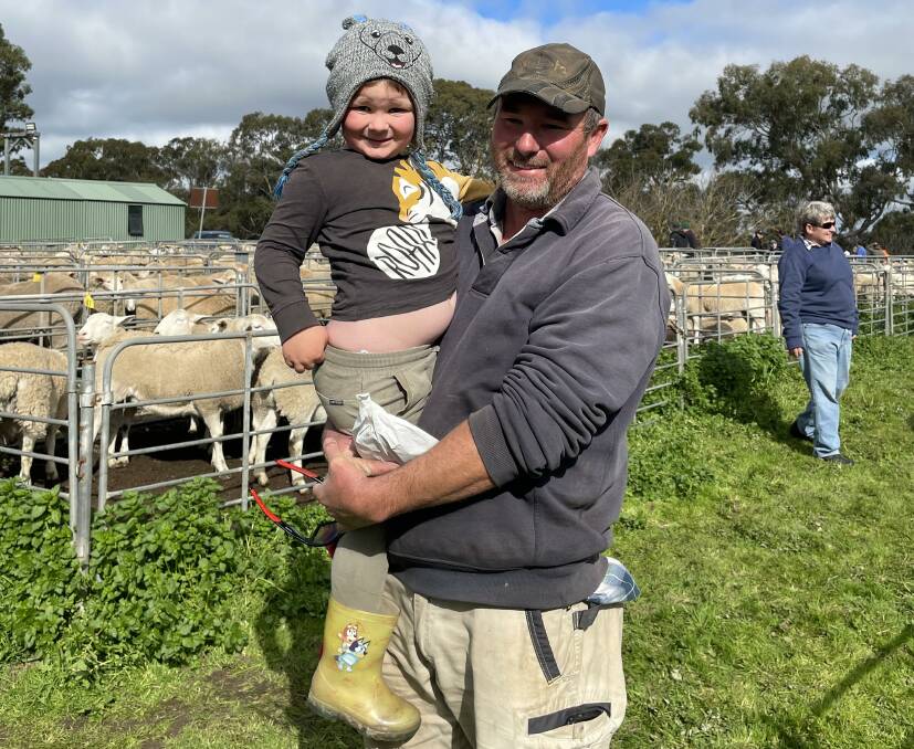 SMILES: Mostyn, 3, and Danny Pauley, Kenton Valley, SA, at last month's Mount Pleasant, SA, sheep market. 