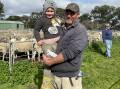 SMILES: Mostyn, 3, and Danny Pauley, Kenton Valley, SA, at last month's Mount Pleasant, SA, sheep market. 
