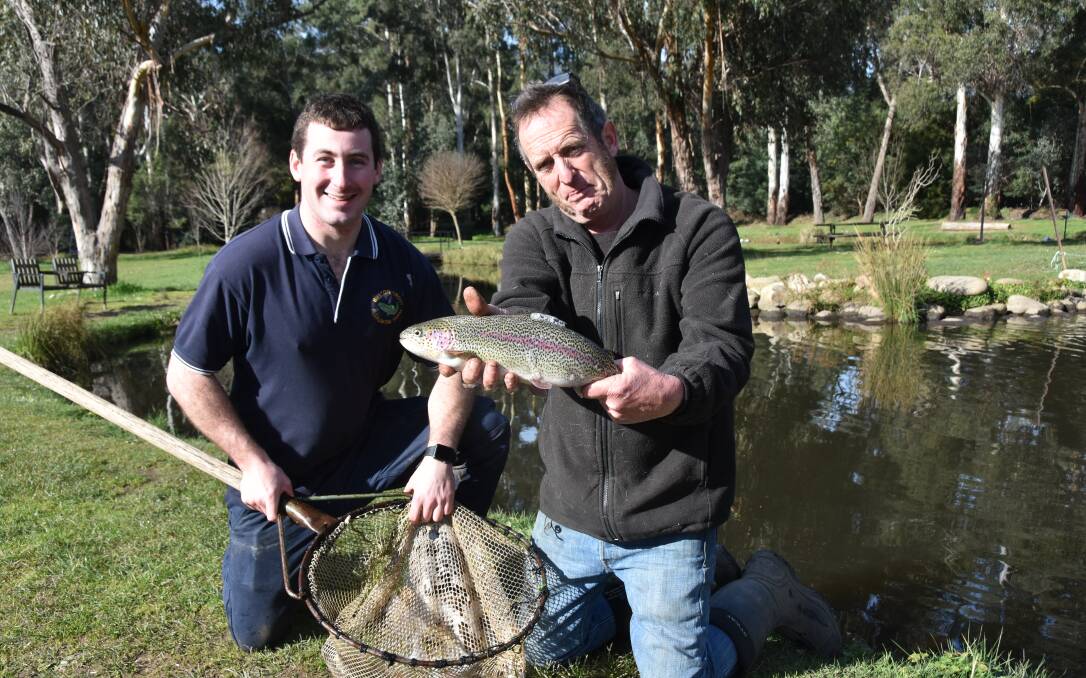CHASING RAINBOWS: Buxton Trout & Salmon manager Matt Carlton and owner Mitch MacRae with a fine specimen of the aptly-named rainbow trout.