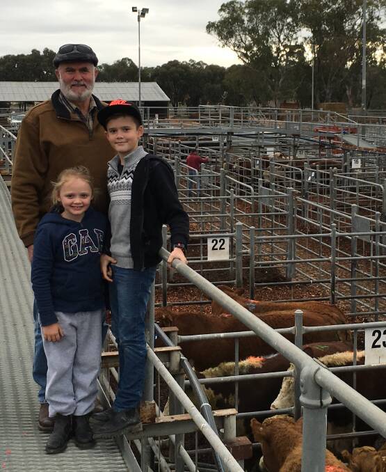 MARKET: Drew Harris, pictured with grandchildren Sophie and Jimmy, sold a very good run of vendor bred charolais-crossed steers at Swan Hill. 