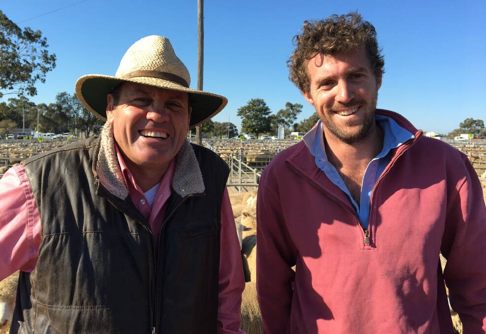 SOLD: Elders stock agent Steve Grantham with Corowa's Allan Austin, who sold 114 shorn X Bred lambs to $154 and 67 Merino lambs for $127. Lamb numbers at Corowa decreased significantly in a plainer quality yarding. 