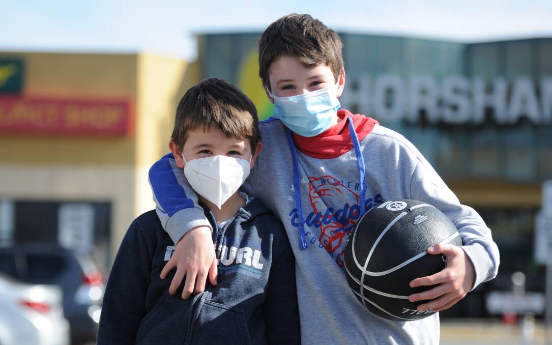 HAPPY TO PLAY THEIR PART: Bailey and Taylor Hartas wearing facemasks last month. It is not compulsory for children under 12 to wear face masks. Photo by Richard Crabtree.