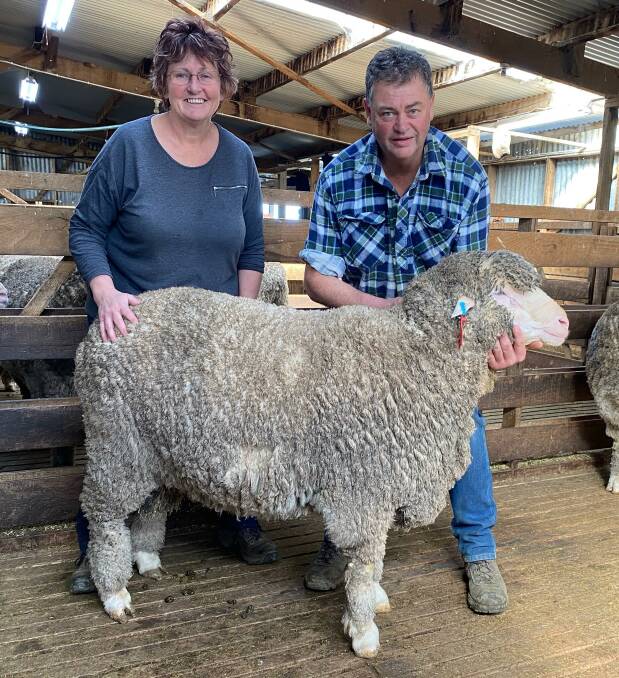 RESULT: Jackie and Kelvin Pendergast with the top-priced ram, which sold for $12,000 and made a new record for the sale. 