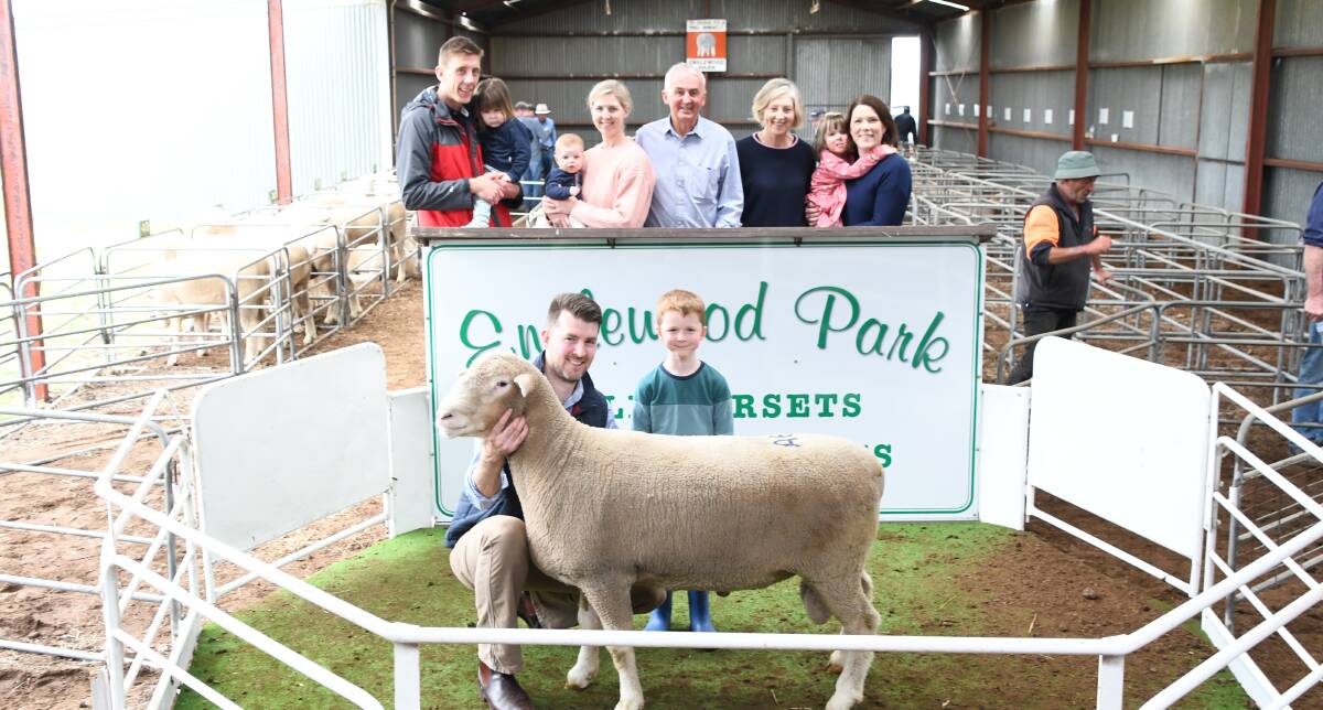 FAMILY AFFAIR: Englewood Park principal Geoff Oliver (centre), and family with the top-priced ram, Lot 6A, held by son Steve Oliver.