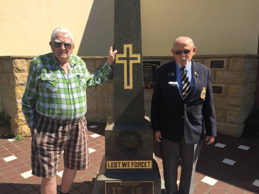 Trevor Brooker and Tom Banister standing at the memorial outside the Dungog Memorial RSL Club.