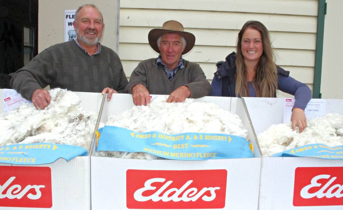 Elders’ Mal Nicholls with Bert and Indi Ah Sam, Omeo, and the three winning fleeces. Bert and Brendan Ah Sam have donated the clips to be auctioned on January 15. High country woolgrowers rallied to Mr Nicholls’ request and donated 30 top-line fleeces. 