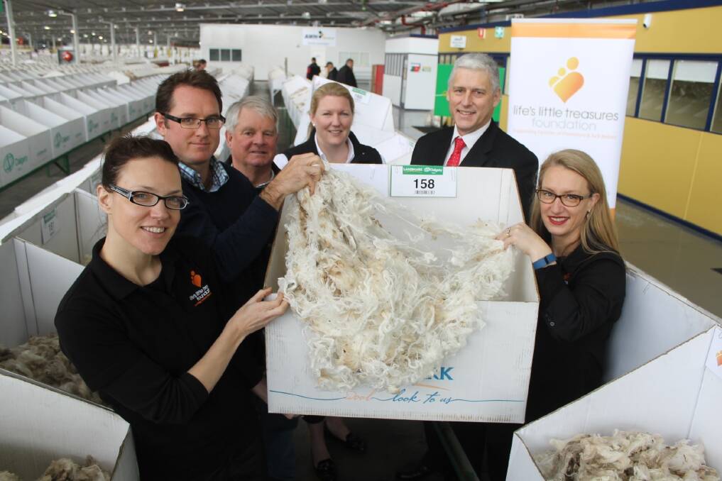 Life's Little Treasures Foundation's Beth Allan, United Wool Company's Andrew Jackson, Australian Sheep & Wool Show's Graeme Harvey, Landmark's Candice Cordy, AWTA's Tim Steere and Life's Little Treasures' Kelli Hugo check out some of the donated wool that went under the hammer last Wednesday.