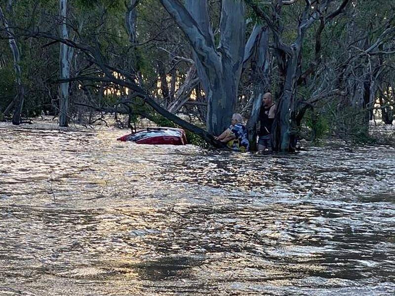A man risked his life to help rescue a 74-year-old woman whose car was swept into floodwaters. (HANDOUT/VICTORIA POLICE)