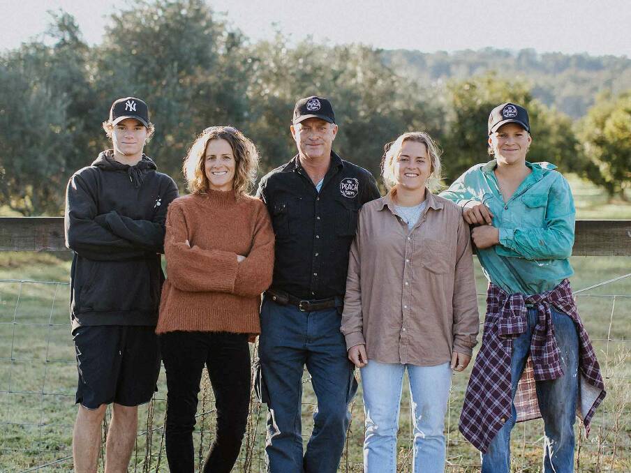 FRUITFUL: The Cameron family, Kickie, Edwina, Ray, Meg and Oliver, live the sweet life growing glorious peaches and nectarines at The Peach Farm at Mororo. Photos: Minyarose Photography.
