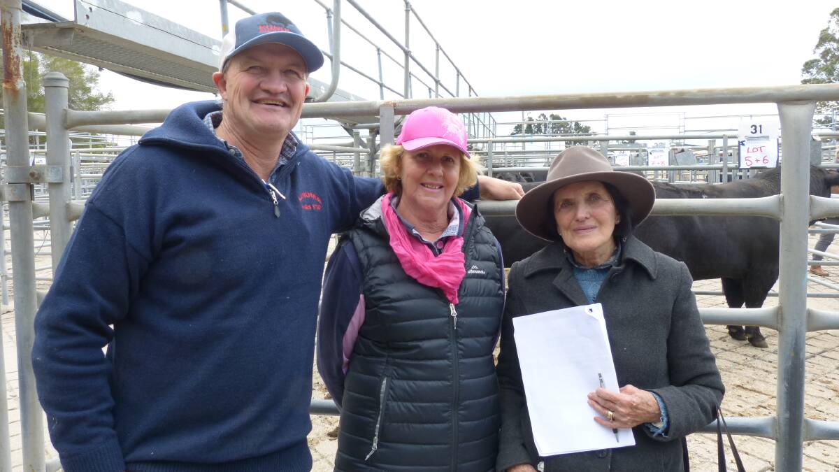 Smiling, after their Kunuma Angus Stud bull sale are Dean Lynch, left, and Pat Lynch, with Robyn Kuch, who purchased the highest price bull, Kunuma L127 (APR), for $6000.