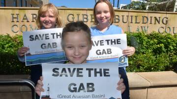 Claire and Cate Kennedy, 9, from Dirranbandi with (front) Lola Andreasson, 6, of Brisbane, show their support for the GAB at AgForce's court case earlier this year. Picture: Alison Paterson