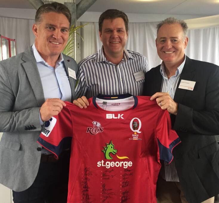 LUCKY DOOR PRIZE: Warwick Fraser, Fraser's Livestock Transport, Warwick, with Wallaby legends Tim Horan and David Campese.